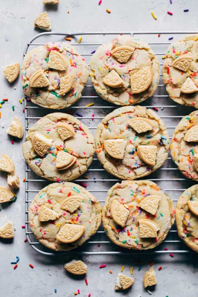 a tray of funfetti cookies topped with golden oreos