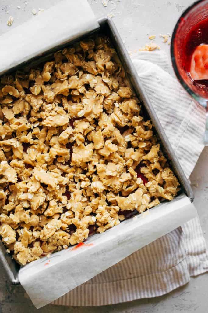 peanut butter oat crumbles on top of peanut butter and jelly bars