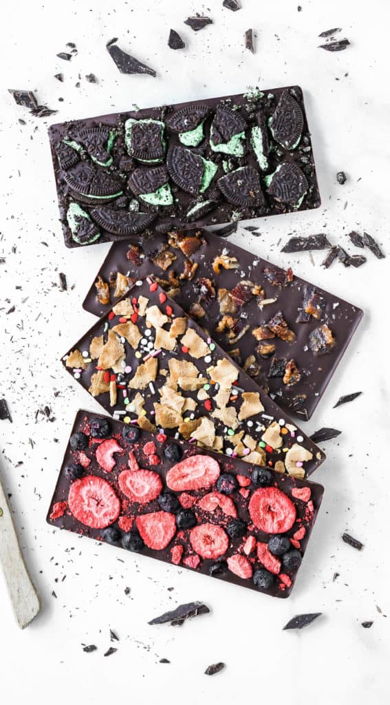 four difference homemade chocolate bars with tons of toppings