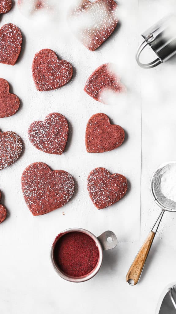 heart shaped shortbread cookies laying on parchment paper