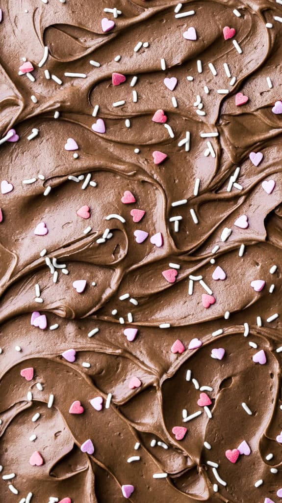 swirls of chocolate frosting topped with heart sprinkles