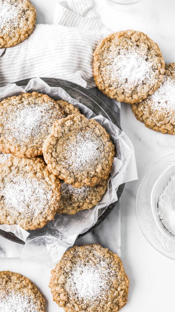 a tray of the best oatmeal cookies topped with powdered sugar