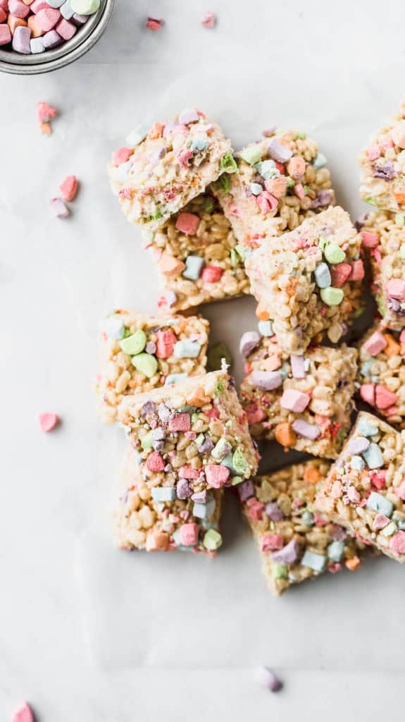 lucky charms marshmallow treats scattered on parchment paper