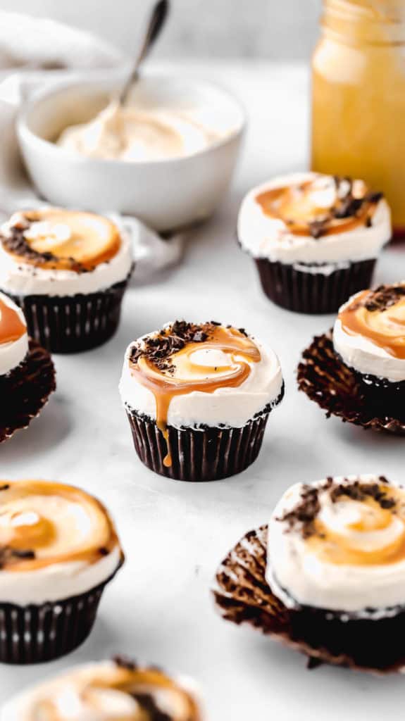 guinness chocolate cupcakes scattered throughout a marble surface