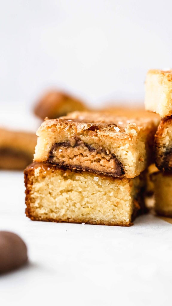 a stack of reese's stuffed white chocolate brownies