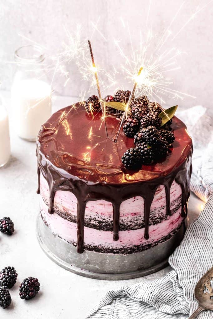 a layered blackberry chocolate cake with sparklers