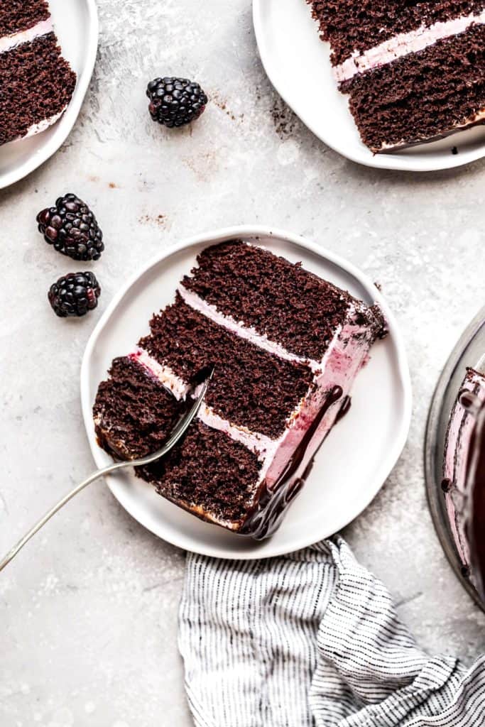 a slice of chocolate blackberry cake on a plate