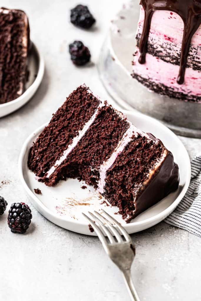 a slice of chocolate blackberry cake on a plate