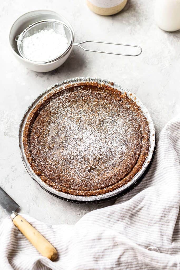 a gooey butter cinnamon pie with powdered sugar on top