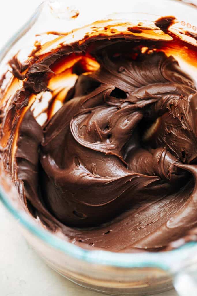 a bowl of chocolate ganache frosting