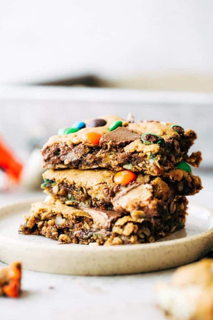 a stack of leftover halloween candy cookie bars