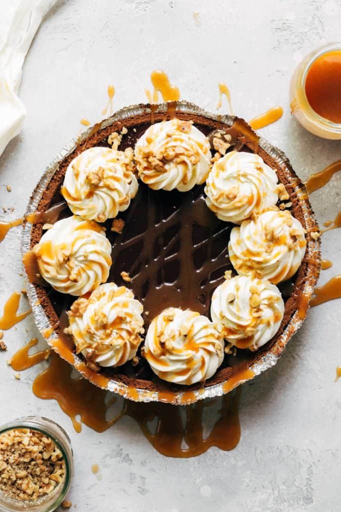 a complete turtle pie with caramel drizzled on top
