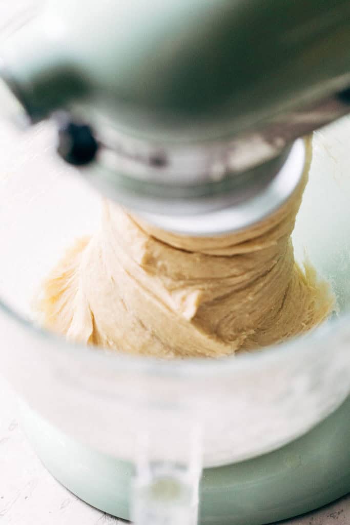 Cinnamon roll dough in bowl of stand mixer