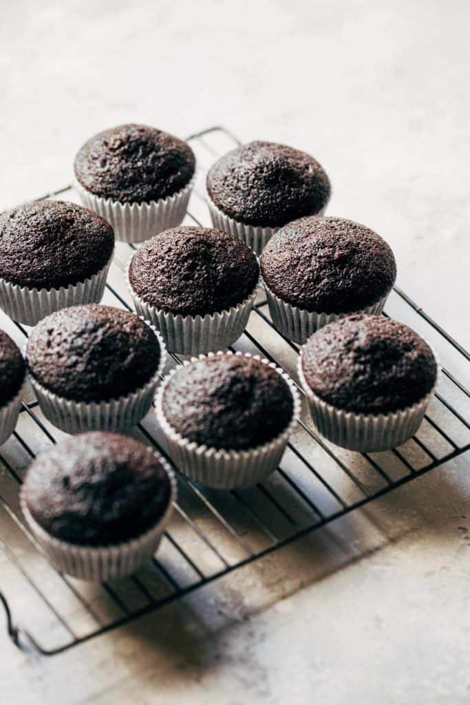 baked chocolate cupcakes on a cooling rack