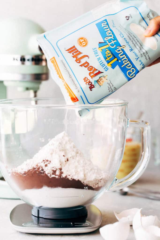 pouring dry ingredients into a mixing bowl