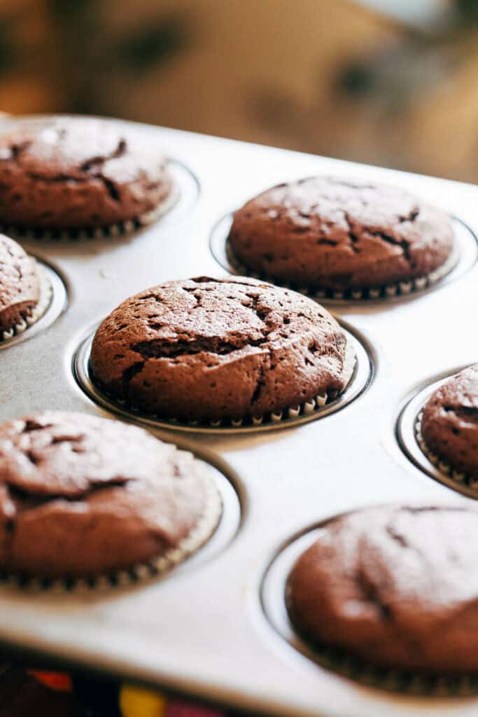 freshly baked flourless chocolate cake muffins in a muffin pan