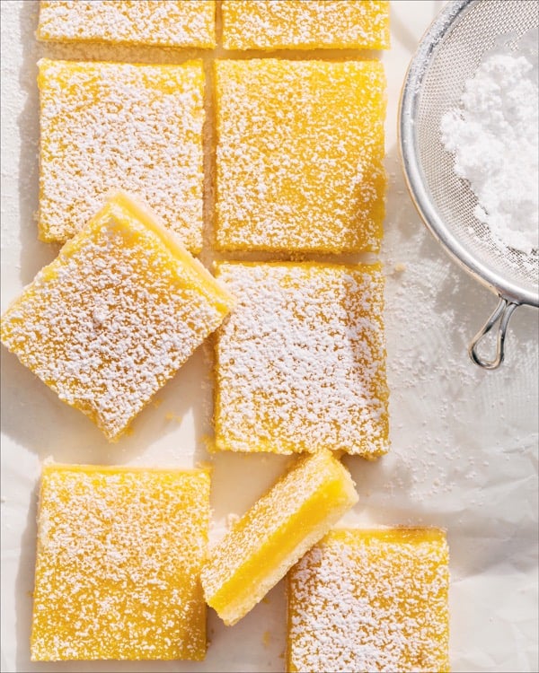 Lemon pudding bars dusted with powdered sugar.