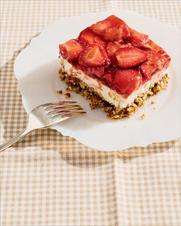 A slice of strawberry pretzel salad on a white plate.