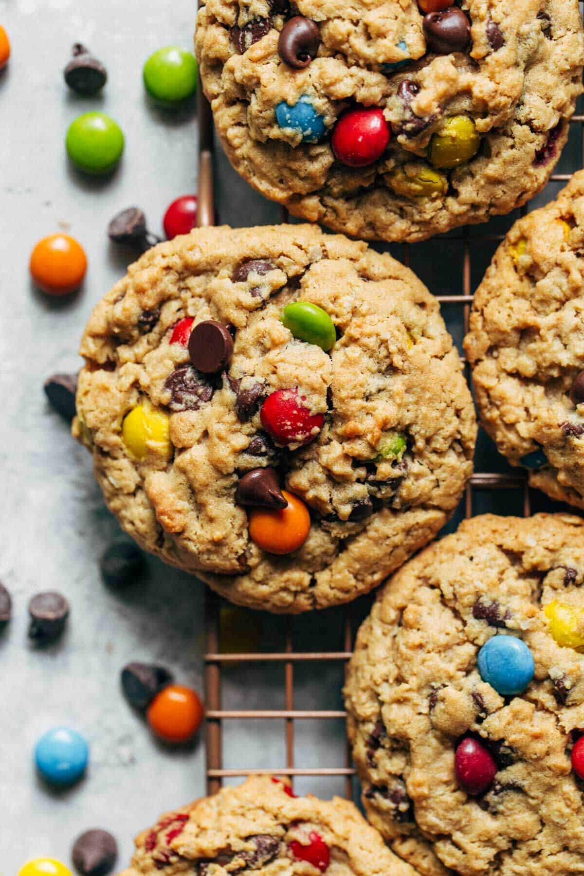 a monster cookie resting on a cooling rack