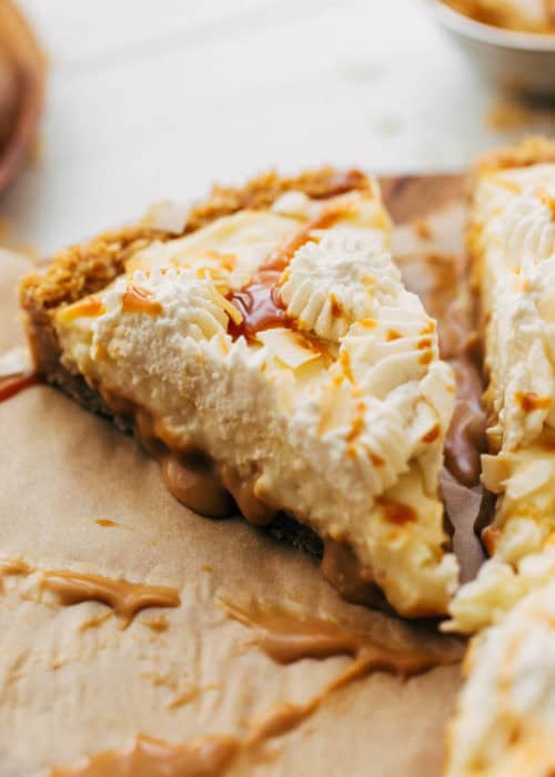 close up on a slice of coconut cream pie with a layer of caramel on the bottom