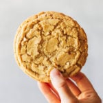 holding up a large peanut butter cookie