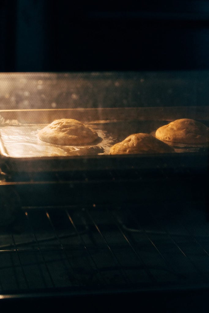large peanut butter cookies baking inside an oven
