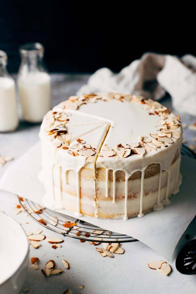 a naked layer cake with a white chocolate drip