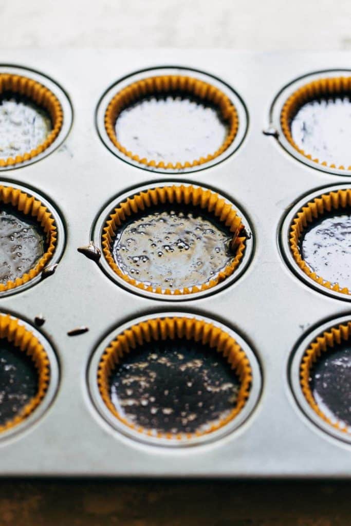 chocolate cupcake batter poured into cupcake liners