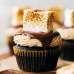 close up on a chocolate cupcake topped with a homemade toasted marshmallow