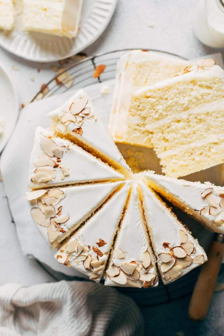 close up on the top view of a sliced almond cake