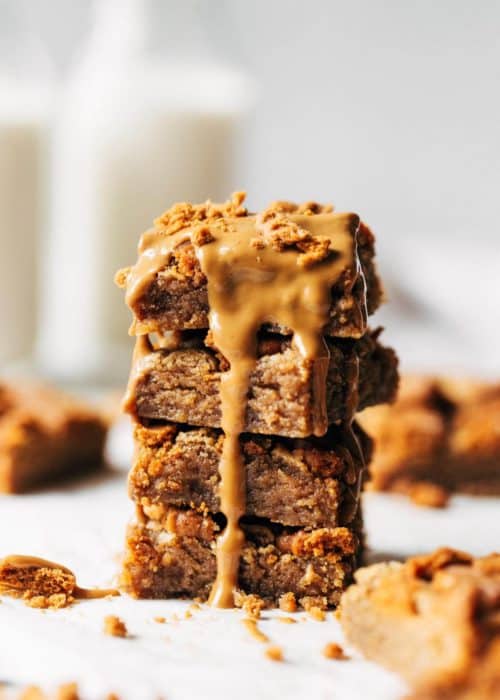 a stack of cookie butter blondies with cookie butter melted on top