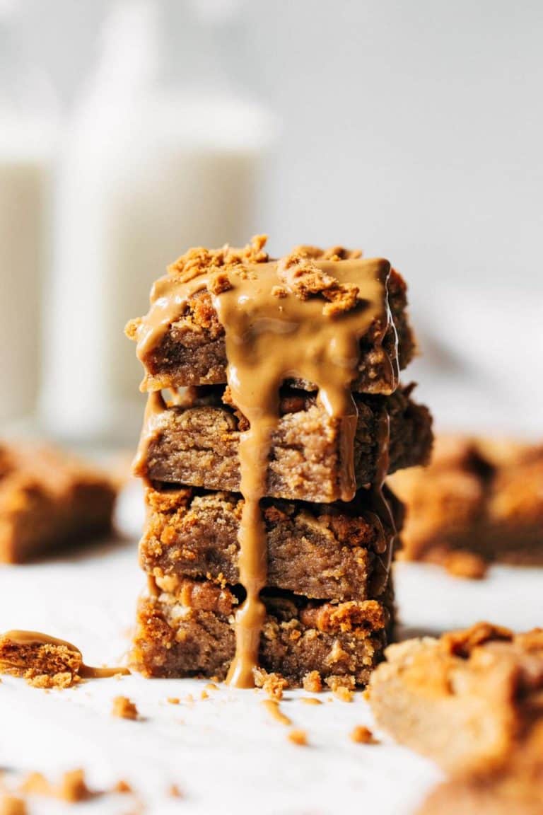 a stack of cookie butter blondies with cookie butter melted on top