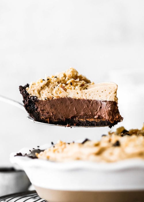a slice of chocolate peanut butter pie being lifted out of the pie dish