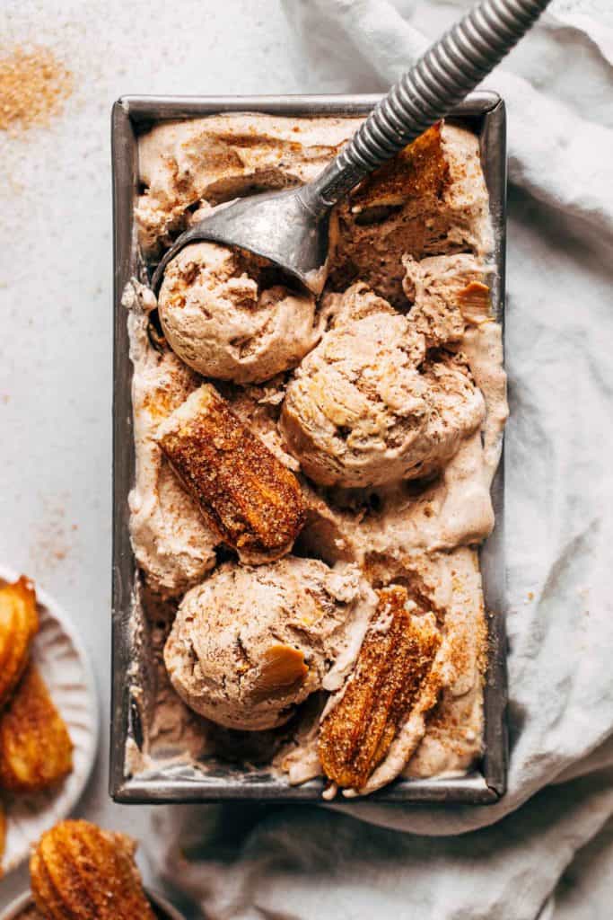 scoops of churro ice cream in a loaf pan