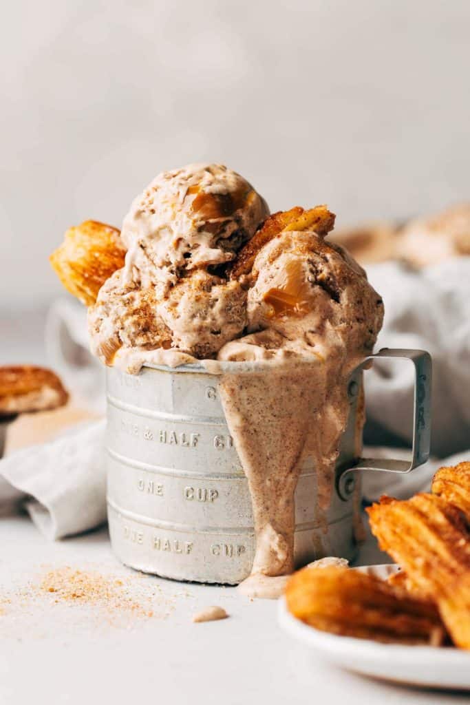 churro ice cream in an old tin measuring cup