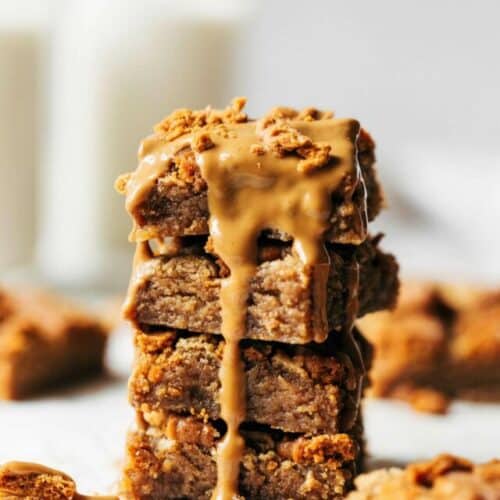 a stack of cookie butter blondies with cookie butter melted on top