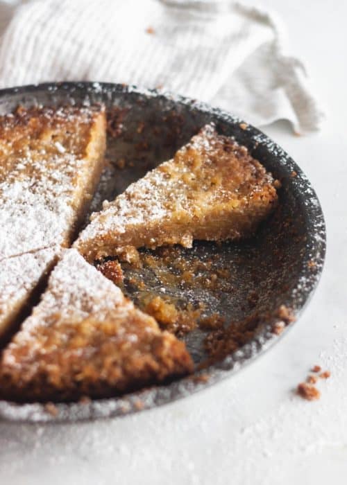 sliced crack pie with powdered sugar on top