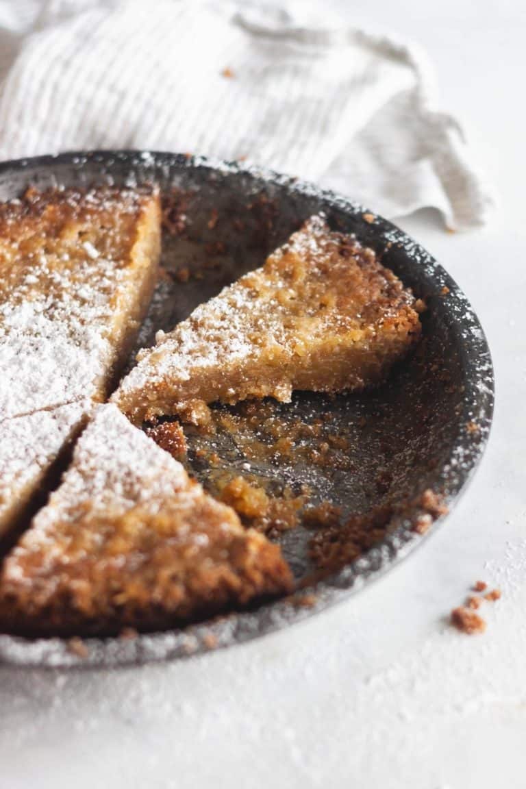 sliced crack pie with powdered sugar on top