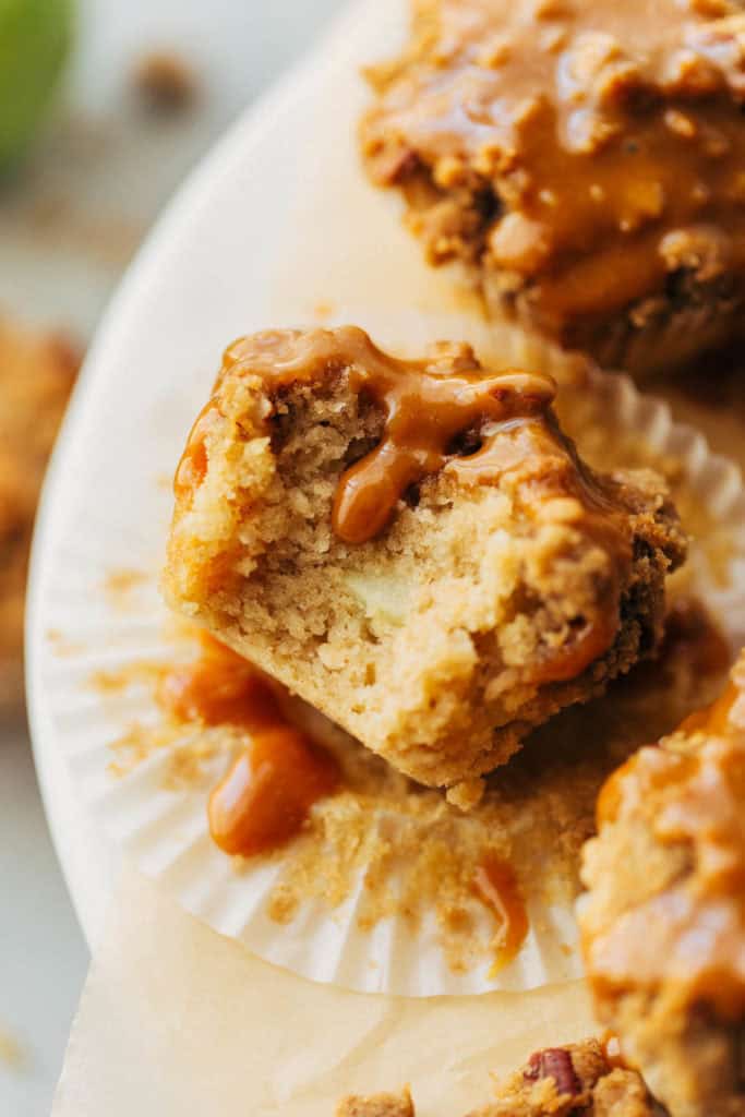 close up on a bite taken out of an apple muffin