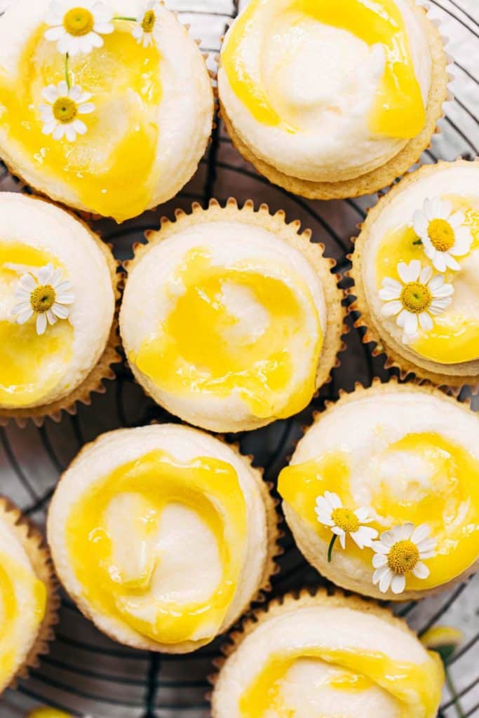 the tops of lemon cupcakes swirled with lemon curd