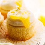 lemon curd dripping down the side of an unwrapped lemon cupcake