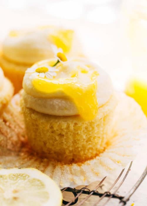 lemon curd dripping down the side of an unwrapped lemon cupcake