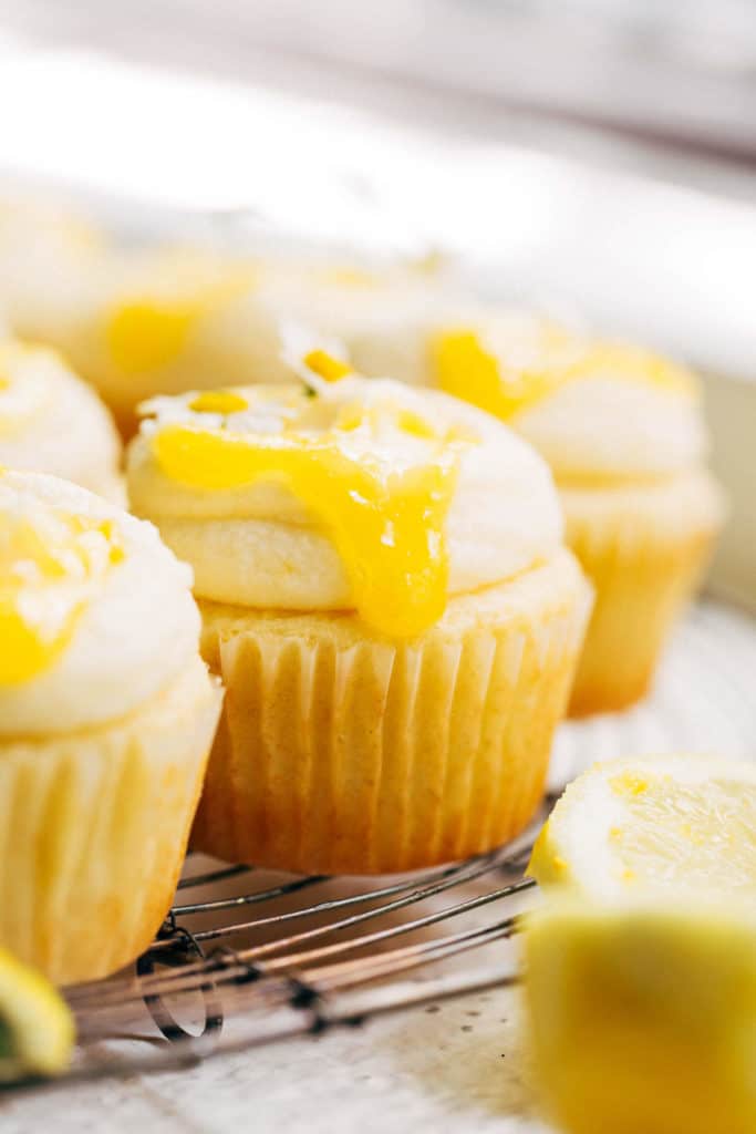 lemon curd dripping down the side of a cupcake