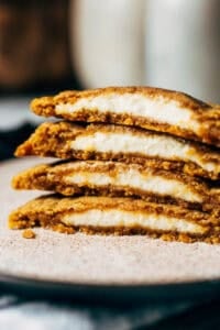 inside a stack of pumpkin cookies filled with cream cheese