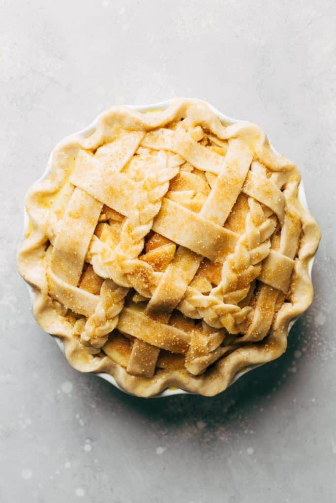 the top of an apple pie that's ready to bake