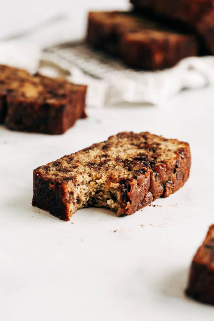 a bite taken from a slice of chocolate chip banana bread