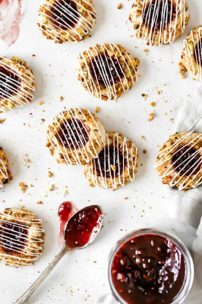 pistachio raspberry thumbprint cookies scattered