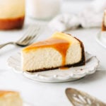 a slice of caramel cheesecake on a dessert plate