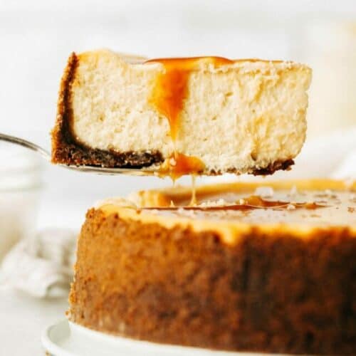 lifting out a slice of salted caramel cheescake