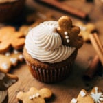 close up on a gingerbread cupcake topped with a mini gingerbread cookie